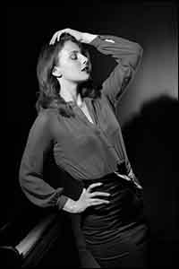 Classic Hollywood monochrome image of a woman and a piano