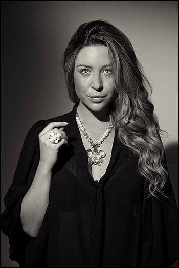 Toned monochrome portrait photograph of a young woman.