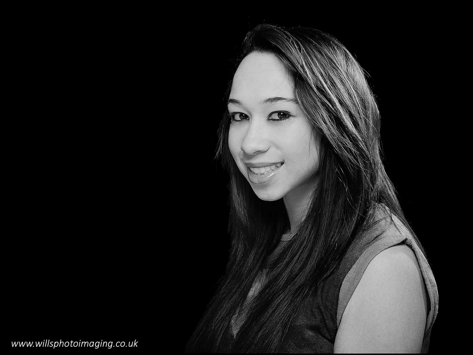 Black and white portrait photograph of a woman with long black hair