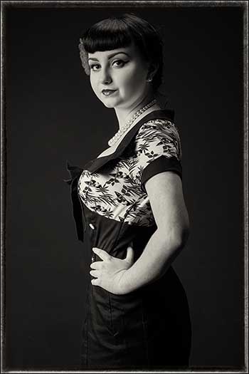 Vintage styled toned monochrome photograph of a woman in vintage style clothing.